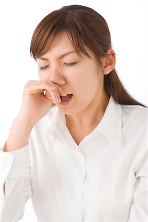 simsearch:685-02938515,k - A young woman sneezing Foto de stock - Royalty Free Premium, Número: 685-02938555