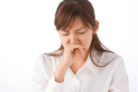 simsearch:685-02938515,k - A young woman sneezing Stock Photo - Premium Royalty-Free, Code: 685-02938556