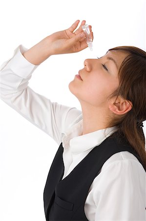 simsearch:685-02938515,k - A young woman applying eye drop Foto de stock - Royalty Free Premium, Número: 685-02938553