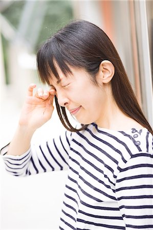 simsearch:685-02938526,k - A woman rubbing her eyes Stock Photo - Premium Royalty-Free, Code: 685-02938561