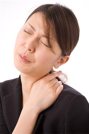 simsearch:685-02938526,k - A young woman suffering from pain on shoulder Stock Photo - Premium Royalty-Free, Code: 685-02938573