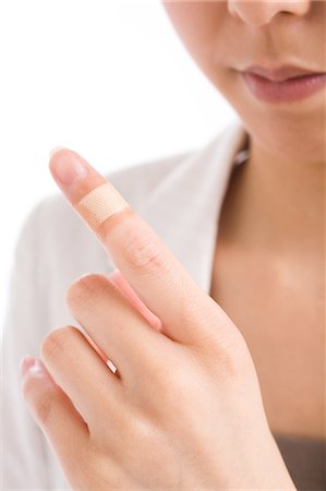 simsearch:685-02938515,k - Close-up of woman's finger with adhesive bandage Stock Photo - Premium Royalty-Free, Code: 685-02938584