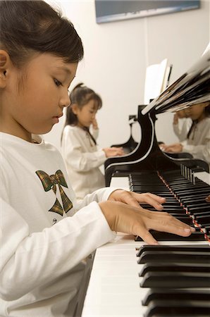 piano practice - Girls playing piano Stock Photo - Premium Royalty-Free, Code: 685-02938786