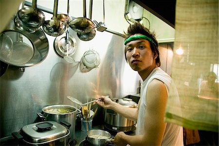 simsearch:685-02938851,k - Young man cooking in restaurant kitchen Stock Photo - Premium Royalty-Free, Code: 685-02938864