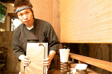 simsearch:685-02938851,k - Young man cleaning table at restaurant Stock Photo - Premium Royalty-Free, Code: 685-02938870