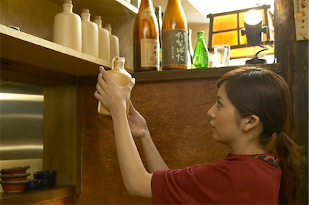 simsearch:685-02938851,k - Young woman holding a bottle of alcohol Stock Photo - Premium Royalty-Free, Code: 685-02938902