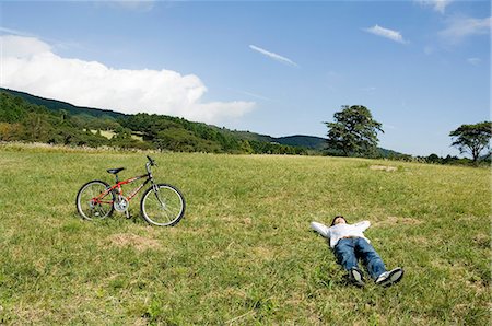 simsearch:685-02939244,k - Young man lying down on field Stock Photo - Premium Royalty-Free, Code: 685-02939249