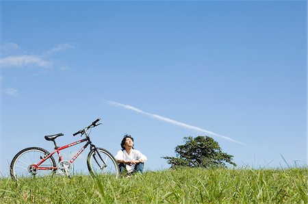 simsearch:685-02939244,k - Young man sitting next to bicycle Stock Photo - Premium Royalty-Free, Code: 685-02939240