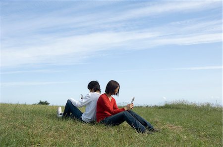 simsearch:685-02939244,k - Young couple sitting back to back Stock Photo - Premium Royalty-Free, Code: 685-02939258