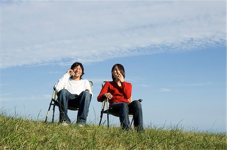 simsearch:685-02939244,k - Young couple talking on mobile phones Stock Photo - Premium Royalty-Free, Code: 685-02939260