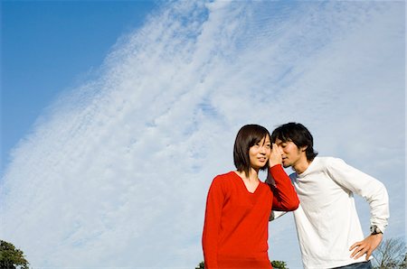simsearch:685-02939244,k - Young man whispering to young woman Stock Photo - Premium Royalty-Free, Code: 685-02939285