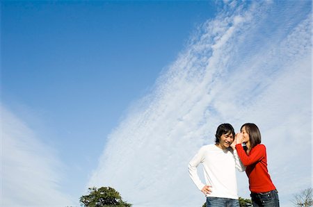 simsearch:685-02939244,k - Young woman whispering to young man Stock Photo - Premium Royalty-Free, Code: 685-02939286