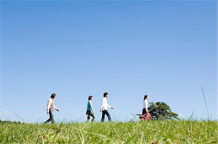 simsearch:685-02939244,k - Four young people walking in field Stock Photo - Premium Royalty-Free, Code: 685-02939297