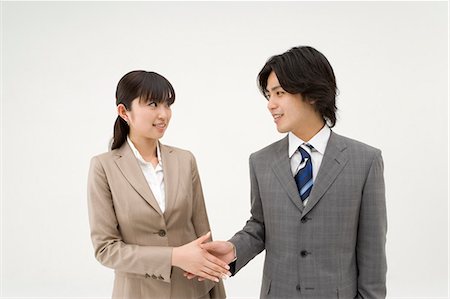 Two business people shaking hands Stock Photo - Premium Royalty-Free, Code: 685-02939344