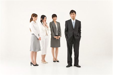 Three businesswomen looking at businessman Stock Photo - Premium Royalty-Free, Code: 685-02939384