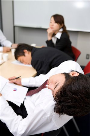 Young businessmen sleeping during meeting Stock Photo - Premium Royalty-Free, Code: 685-02939665