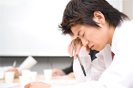 Young businessman sleeping during meeting Stock Photo - Premium Royalty-Free, Code: 685-02939660