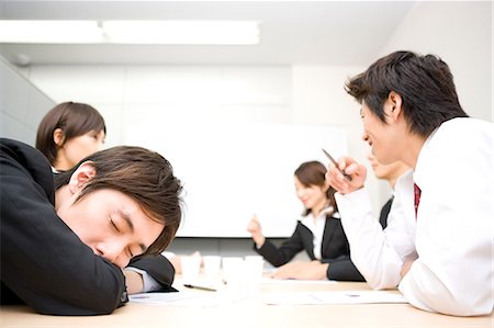 Young businessman sleeping during meeting Stock Photo - Premium Royalty-Free, Code: 685-02939662