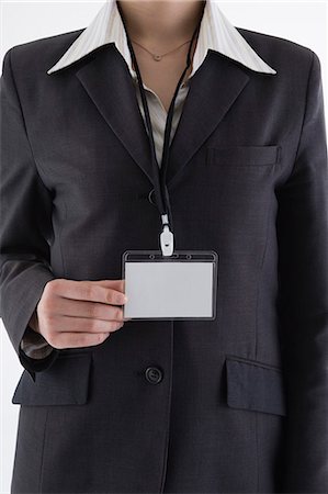 simsearch:685-02940140,k - Businesswoman wearing ID card Stock Photo - Premium Royalty-Free, Code: 685-02940124