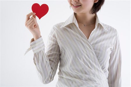 simsearch:685-02940140,k - Businesswoman holding heart-shaped paper Stock Photo - Premium Royalty-Free, Code: 685-02940138