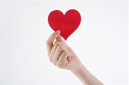 simsearch:685-02940140,k - Woman's hand holding heart-shaped paper Stock Photo - Premium Royalty-Free, Code: 685-02940139