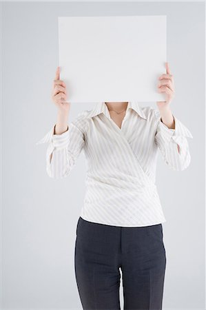 simsearch:685-02940140,k - Businesswoman holding blank placard Stock Photo - Premium Royalty-Free, Code: 685-02940132