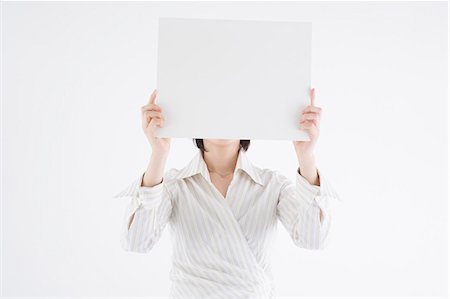 simsearch:685-02940140,k - Businesswoman holding blank placard Stock Photo - Premium Royalty-Free, Code: 685-02940133