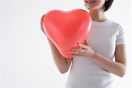 simsearch:685-02940140,k - Woman holding heart-shaped balloon Stock Photo - Premium Royalty-Free, Code: 685-02940144