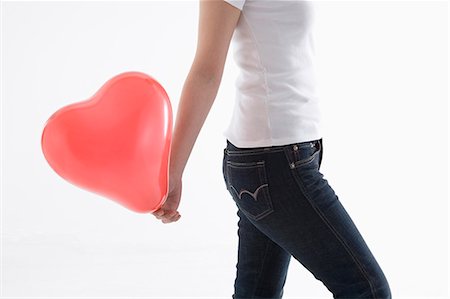 simsearch:685-02940140,k - Woman holding heart-shaped balloon Stock Photo - Premium Royalty-Free, Code: 685-02940145