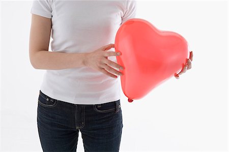 simsearch:685-02940140,k - Woman holding heart-shaped balloon Stock Photo - Premium Royalty-Free, Code: 685-02940146