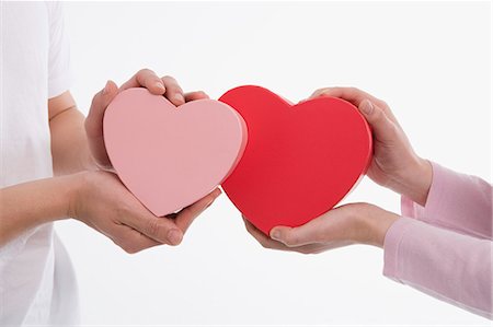 simsearch:685-02940140,k - Man and woman holding heart-shaped boxes Stock Photo - Premium Royalty-Free, Code: 685-02940149
