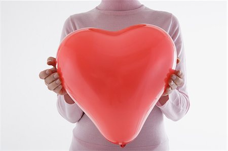simsearch:685-02940140,k - Woman holding heart-shaped balloon Stock Photo - Premium Royalty-Free, Code: 685-02940143