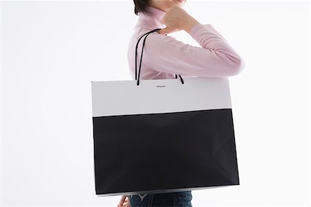 simsearch:685-02940184,k - Woman holding shopping bag Foto de stock - Sin royalties Premium, Código: 685-02940157