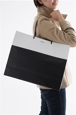 simsearch:685-02940184,k - Woman holding shopping bag Foto de stock - Sin royalties Premium, Código: 685-02940158