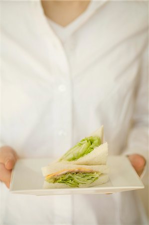simsearch:685-02940140,k - Young woman holding plate of sandwich Stock Photo - Premium Royalty-Free, Code: 685-02940402
