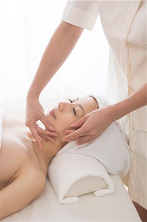 simsearch:685-02940844,k - Young woman having facial massage Fotografie stock - Premium Royalty-Free, Codice: 685-02940833