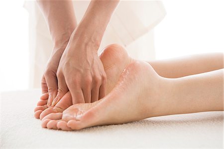 simsearch:685-02940844,k - Massage therapist applying foot massage Fotografie stock - Premium Royalty-Free, Codice: 685-02940845
