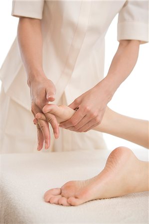simsearch:685-02937281,k - Massage therapist applying foot massage Stock Photo - Premium Royalty-Free, Code: 685-02940846