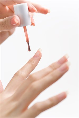 simsearch:685-02940140,k - Young woman applying manicure Stock Photo - Premium Royalty-Free, Code: 685-02940873