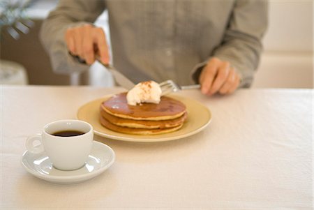 Woman eating pancakes Stock Photo - Premium Royalty-Free, Code: 685-02941195