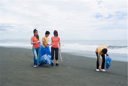 people cleaning rubbish - Young people cleaning beach Stock Photo - Premium Royalty-Free, Code: 685-02941317