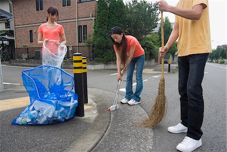 Young people cleaning garbage Stock Photo - Premium Royalty-Free, Code: 685-02941325