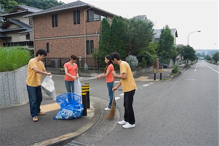 Young people cleaning garbage Stock Photo - Premium Royalty-Free, Code: 685-02941326