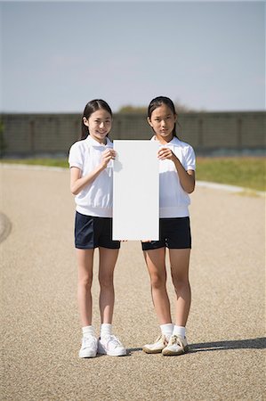 school uniform full length looking at camera - Two schoolgirls wearing gym clothes Stock Photo - Premium Royalty-Free, Code: 685-02941507