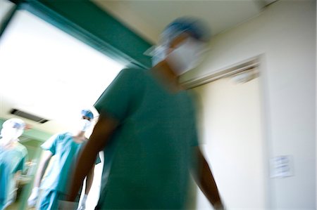 simsearch:685-02941550,k - Doctors and nurse walking out of surgery Stock Photo - Premium Royalty-Free, Code: 685-02941627