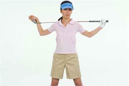 Female golfer standing with golf club Stock Photo - Premium Royalty-Free, Code: 685-02941735