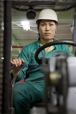 Young man using forklift Stock Photo - Premium Royalty-Free, Code: 685-02941969