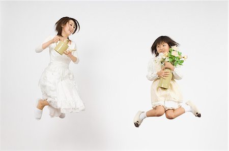 full body white background apron - Girl holding flower and mother holding watering can Stock Photo - Premium Royalty-Free, Code: 685-02942063