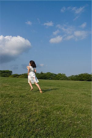 Girl running on grass Stock Photo - Premium Royalty-Free, Code: 685-03081262
