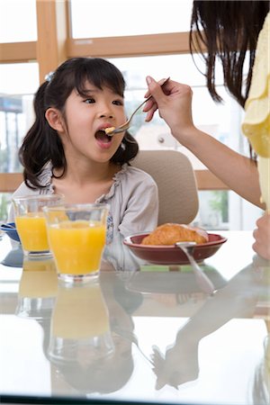 feeding asian family - Family eating breakfast Stock Photo - Premium Royalty-Free, Code: 685-03081418